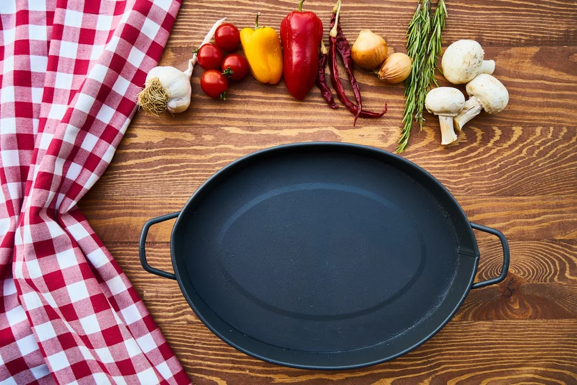 A well-seasoned Lodge cast iron skillet on a gas stovetop with a glossy black surface