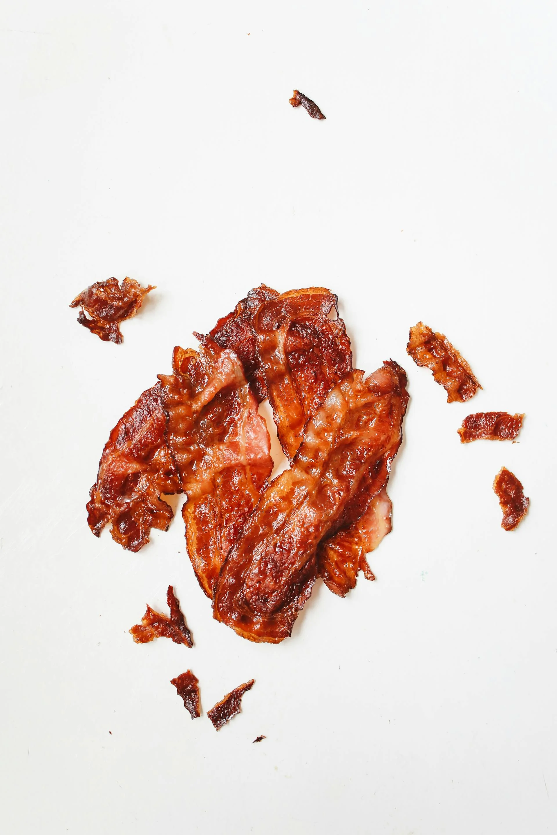 Perfectly crispy oven-baked bacon strips on a sheet pan