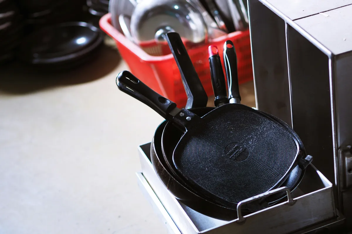 An empty nonstick pan on a white worktop, coating unmarked