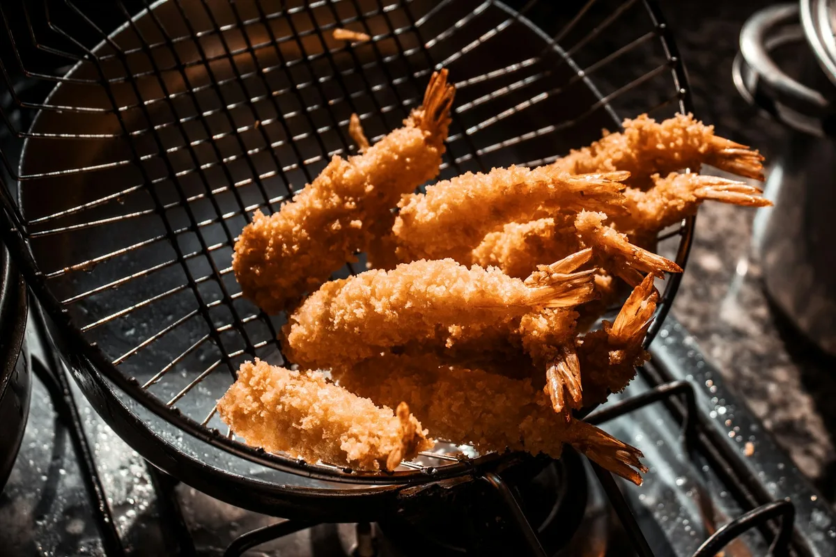 Seasoned shrimp arranged in a cooking basket