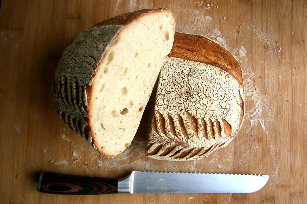 Sourdough cut open on a board, the crumb structure on show