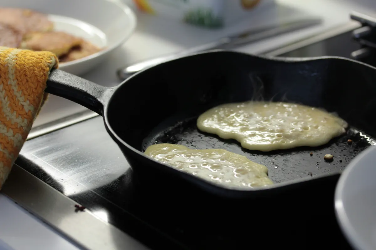 A full frying pan working away on the hob, everything in one place